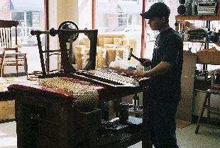 Pre-woven cane is being installed in a chair back